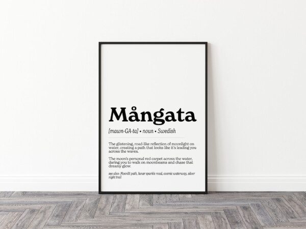 A framed art print featuring the Swedish word "Mångata" in bold text. The definition describes it as "The glistening, road-like reflection of moonlight on water, creating a path that looks like it’s leading you across the waves," with a dreamy and romantic tone.