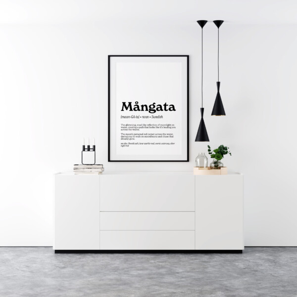 A framed art print featuring the Swedish word "Mångata" in bold text. The definition describes it as "The glistening, road-like reflection of moonlight on water, creating a path that looks like it’s leading you across the waves," with a dreamy and romantic tone.